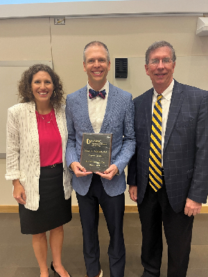 Photo of recipients being presented an award at UMMC OB-GYN Research Day 2024